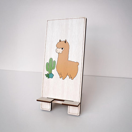 Soporte para celular en MDF con figura de Alpaca con fondo madera claro